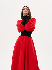 Portrait of a girl model in stylish clothes, in the studio on a light background.