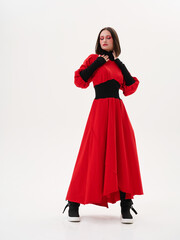 Portrait of a girl model in stylish clothes, in the studio on a light background.