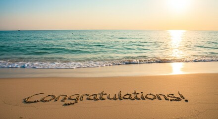 Congratulations Message Written in Sand at Beach with Sunset Light