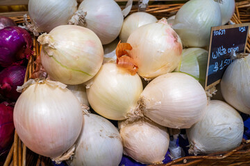 Background of white sweet onion sold at market. Depend on the weather and soil level, onions can deliver different sweetness and colors. Perfect for market service advertising. 