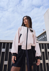 Portrait of a girl model in stylish clothes, shooting in an urban environment.