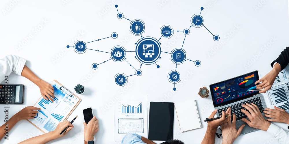 Poster A dynamic team engaged in data management and strategy sessions, utilizing laptops and charts, showcasing collaborative efforts in a modern workspace. Amity