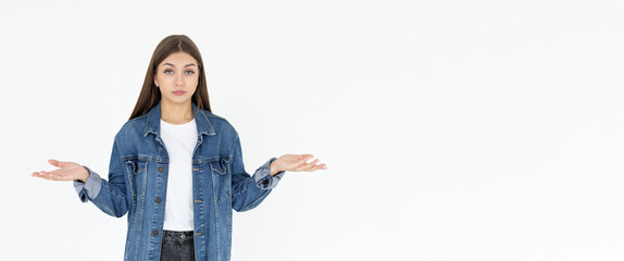 Confused thoughtful confused young woman holding copy space on palm over white background