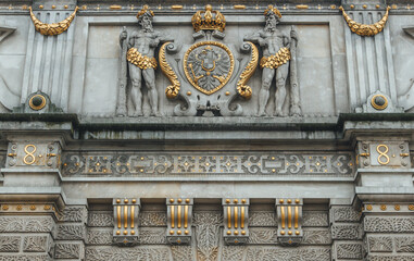 detail of the stone facade sculpture statyes with golden elements 