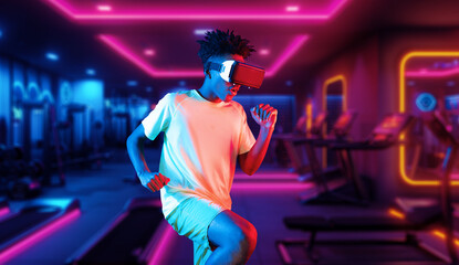 African man wearing VR glasses and casual shirt while exercising at futuristic gym with glowing...