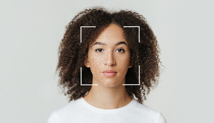 Biometric facial recognition of calm young african american female, isolate on gray background,...