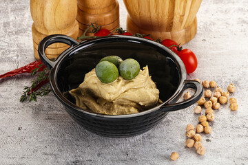 Tasty hummus with green olives