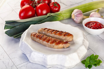 Grilled pork sausages served tomato sauce