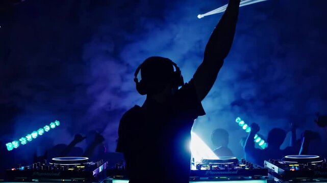 Silhouette of a DJ at a vibrant club, shot from behind at eye level. Colorful lights and smoke create a dynamic video party atmosphere.