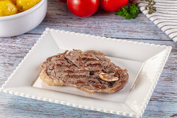Grilled lamb steak with bone