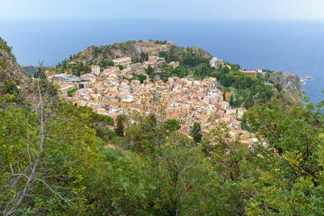 Obraz premium View from above Taormina with the medieval city center, the ancient greek theater and the coastline visible on Sicily, Italy 