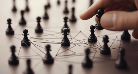 A hand strategically places a black chess piece, connected by network lines to other pieces, suggesting strategic planning and interconnectedness in a business or organizational setting