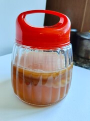 Kombucha tea in a glass jar.  SCOBY or Symbiotic Culture of Bacteria and Yeast. Symbiotic fermentation culture used in the production of kombucha.