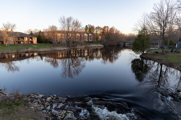 Landscape in Perth, Ontario, Canada in spring. River bank during sunset.