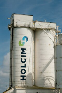 Large white industrial silo structure of Holcim New Zealand Ltd in Auckland, New Zealand