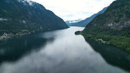 Peaceful Alpine Lake Surrounded by Majestic Mountains and Village Charm