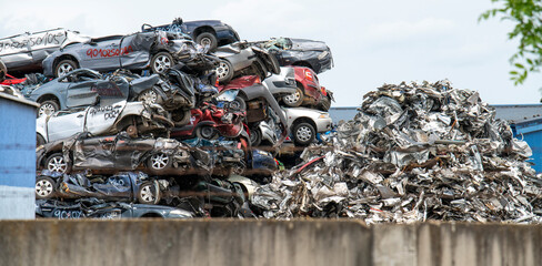 Pile of crushed cars in a junkyard. Car recycling.