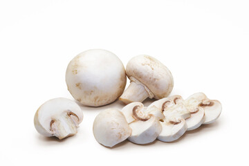 White button mushrooms sliced and whole on white