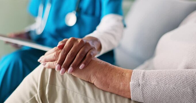 Caregiver, senior woman and holding hands for comfort of bad news, compassion and medical diagnosis. People, tablet and console patient with healthcare report, recovery progress and treatment support