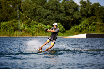 Wakeboarder Riding on Water Holding Tow Rope