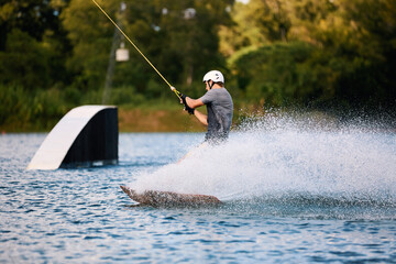 Wakeboarder Riding on Water Holding Tow Rope