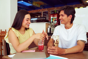 Young couple enjoying drinks and conversation at a cafe