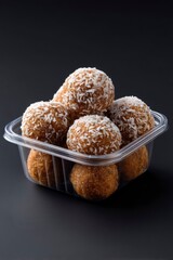 Coconut-Dusted Energy Balls in Clear Container: A Delicious and Appealing Treat