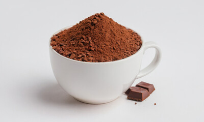 A woman sits enjoying a cup of hot cocoa and a piece of chocolate