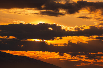 A vibrant sunset casts its colors over Cook Inlet in Anchorage, Alaska.