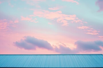 Pastel sunset sky above a metal roof.