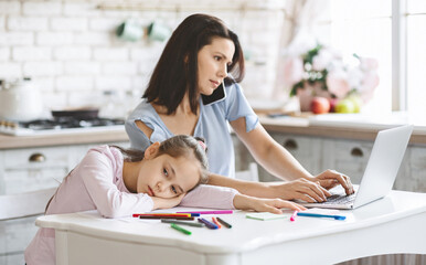 Boredom. Busy mother working in kitchen at home, her sad daughter boring aside, free space