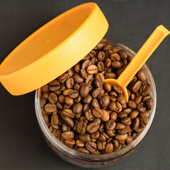 Coffee beans in a jar with a bright yellow lid