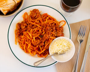 One of varieties of traditional Italian dish is Bolognese pasta. Boiled noodles with minced meat, poured with tomato sauce and seasoned with grated cheese