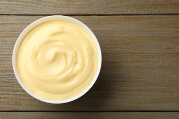 Tasty vanilla pudding on wooden table, top view. Space for text
