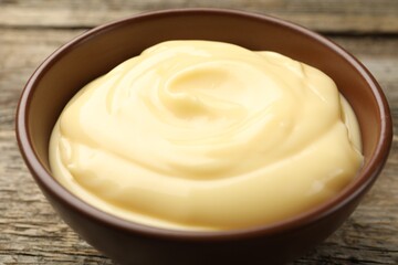 Tasty vanilla pudding on wooden table, closeup