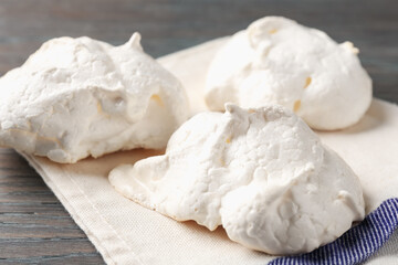Delicious homemade meringue cookies on wooden table, closeup