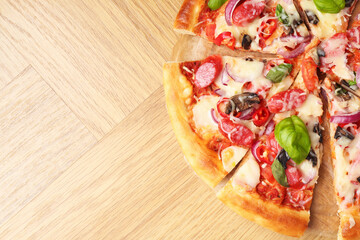 Tasty pizza with thin smoked sausages on wooden table, top view. Space for text