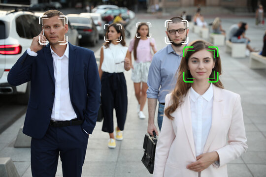 Facial recognition system identifying people on city street, selective focus