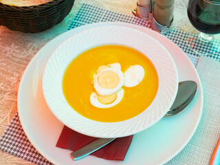Yellow refreshing vegetable cold pureed soup usually served in summer served with sliced boil egg.