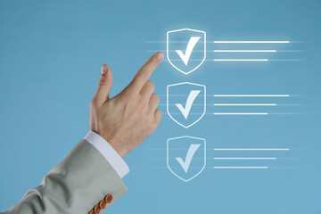 Approved. Man touching check mark on virtual screen against pastel blue background, closeup