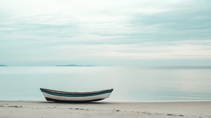 Naklejka premium A small boat is sitting on the beach