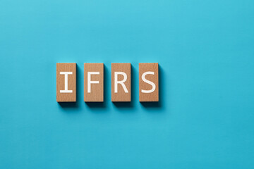Obraz premium There is wood block with the word IFRS. It is an abbreviation for International Financial Reporting Standard as eye-catching image.