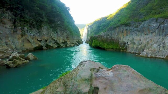 Turquoise water flows through a canyon toward tamul waterfall in san luis potosi, mexico