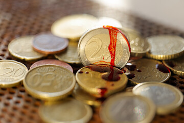 Macro Shot of Euro Coins in Blood . Blood and money.Money stained with blood