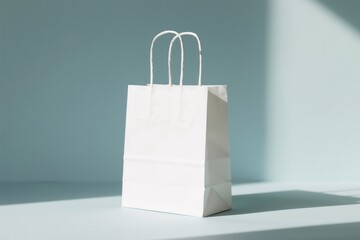 A simple white shopping bag standing in front of a blue background, minimalist scene