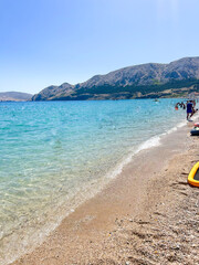 Baška Beach on Krk Island, Croatia, with its pristine pebbles and crystal-clear waters. A stunning...