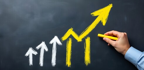 Growth Chart on Blackboard: A hand draws a vibrant yellow upward arrow on a blackboard, symbolizing growth and progress, alongside smaller white arrows illustrating previous incremental gains.