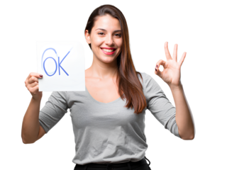 A young woman holding a card with a smiley face and making an -OK- sign, isolated on a transparent background PNG