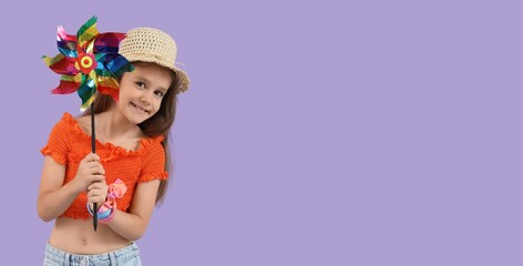 Little girl with toy windmill on lilac background with space for text