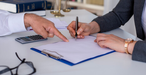 woman signing real estate contract